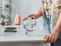 cropped-view-of-soothsayer-touching-orb-near-candl-2023-11-27-05-26-17-utc-1024x683