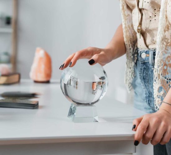 cropped-view-of-soothsayer-touching-orb-near-candl-2023-11-27-05-26-17-utc-1024x683